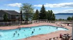 Outdoor heated seasonal pool with view of lake